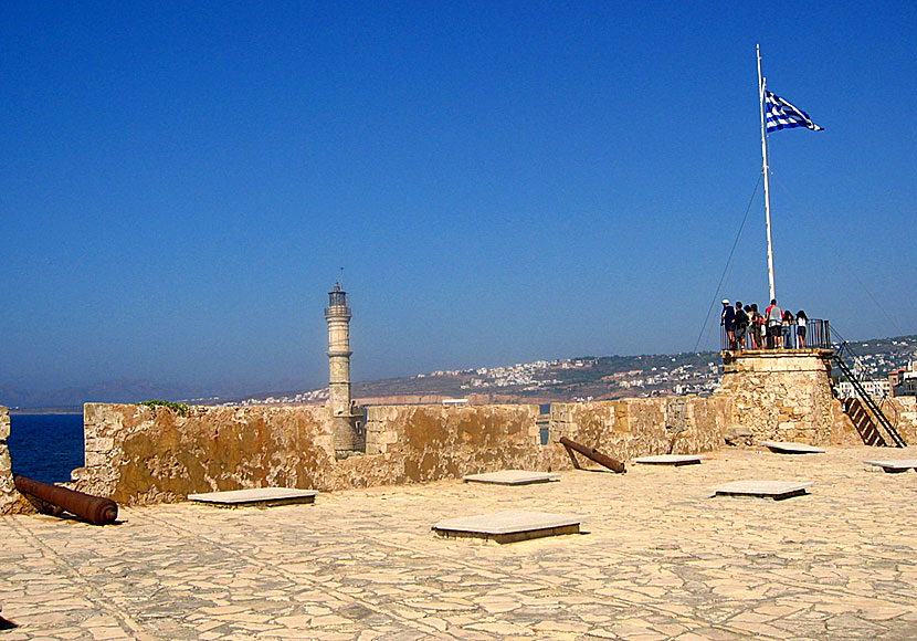 The lighthouse and the Greek flag seen from Firka Fortress in the Venetian port of Chania.