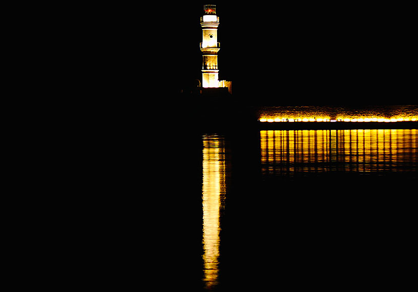 The lighthouse in Chania is beautifully lit in the evening.