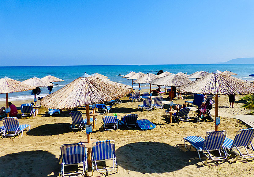 Sunbeds and parasols on Georgioupolis beach in Crete.