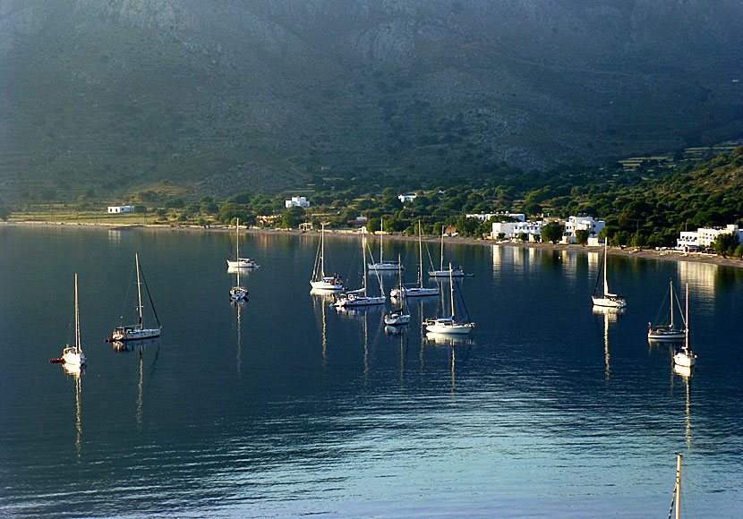 Sunrise and sailboats anchored in the port of Livadia on Tilos.