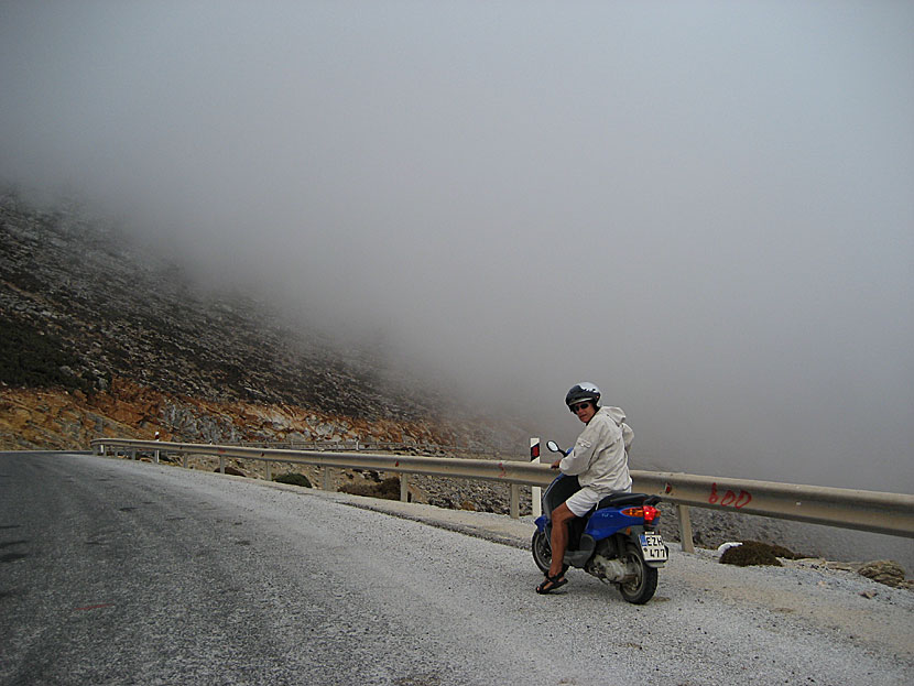 Driving a car, scooter and quad bike in fog between mountains and valleys on Amorgos.