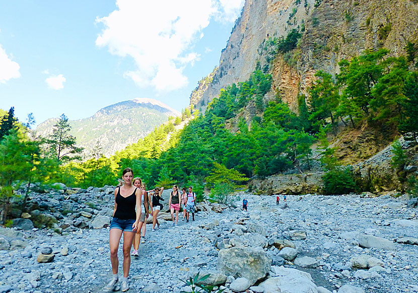 Some are dressed as if they are heading to the beach as they hike the Samaria Gorge.