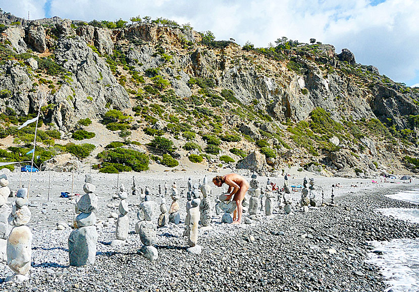 Naked stone builder at the part of the beach popular with nudists.