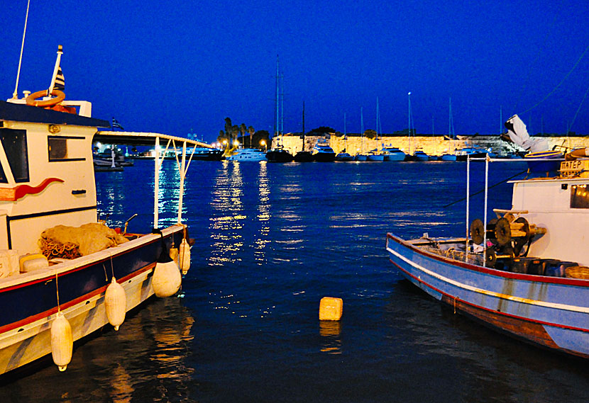 The fish harbor and knight's castle in Kos city in the evening.