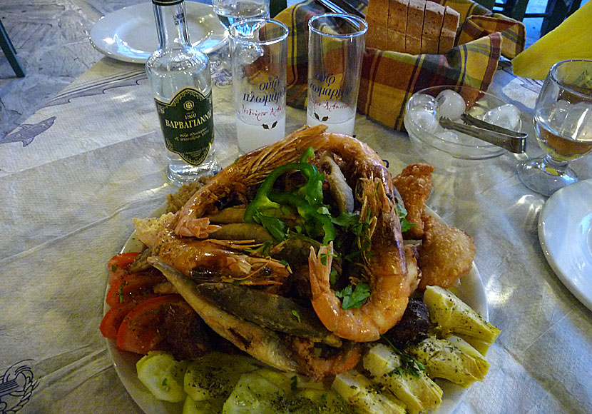 Barbayianni Green Ouzo and a plate of Pikelia in Tinos town.