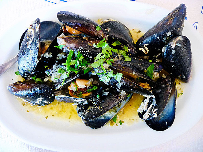 Starters and appetizers from Greece. Mussels saganaki - Midia saganaki - are oven-grated mussels with tomato sauce and feta cheese.