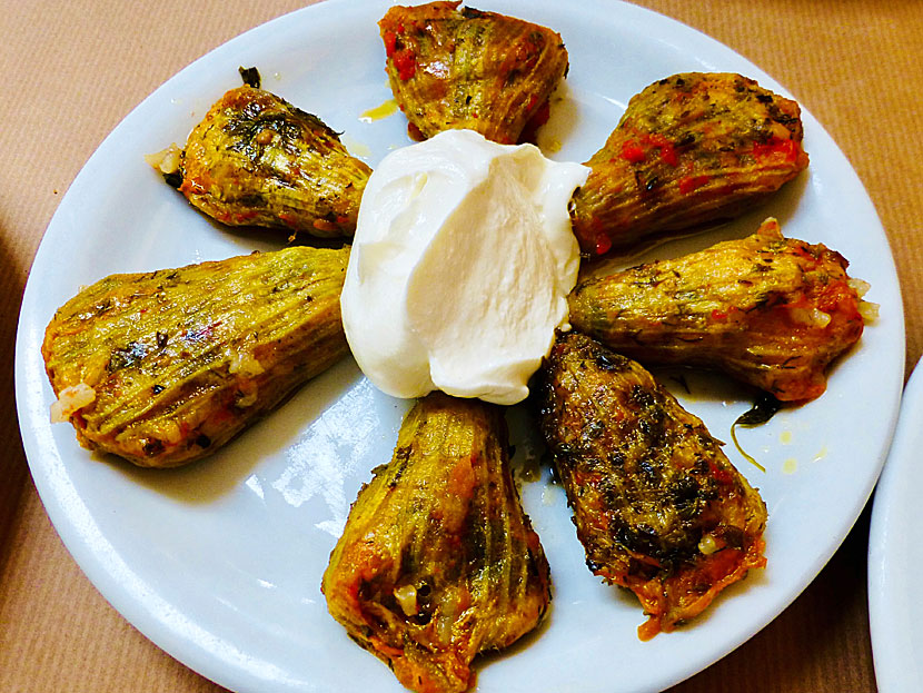 Starters and appetizers from Greece. Stuffed zucchini flowers - Kolokithokorfades - with yogurt on top.