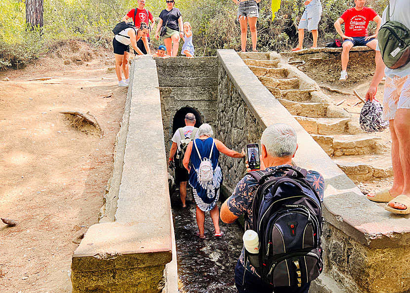 If you don't suffer from claustrophobia, you can follow the path of the water down to the lake through the dark narrow tunnel of Epta Piges.