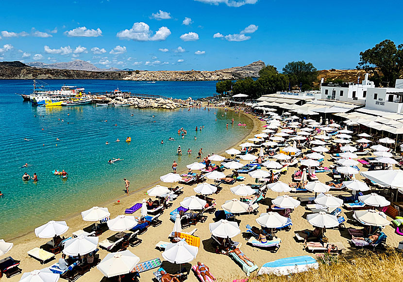 Sunbeds and parasols on the beaches of Lindos in Rhodes.