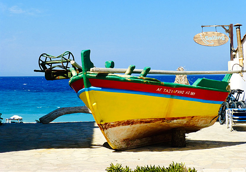 In Kokkari, there is an old colorful fishing boat on land that many people photograph.