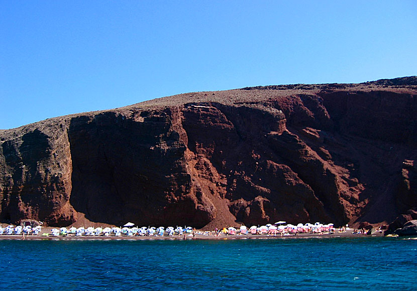 Red beach seen from an excursion boat in the caldera on Santorini.