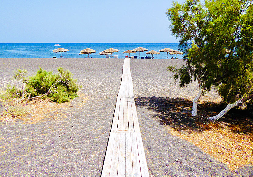 Warm sand at Perissa beach. Use bathing shoes or walk on the wooden planks.